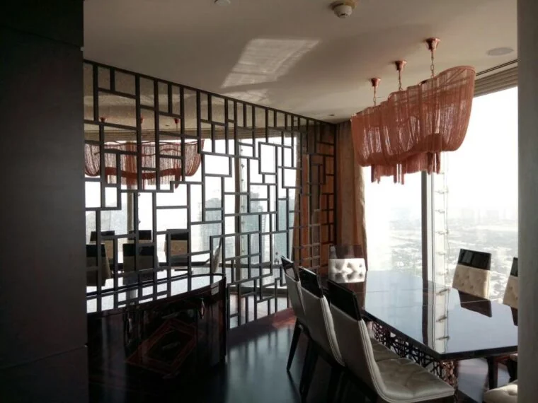 Residential dining area with decorative partition and coordinated finishes