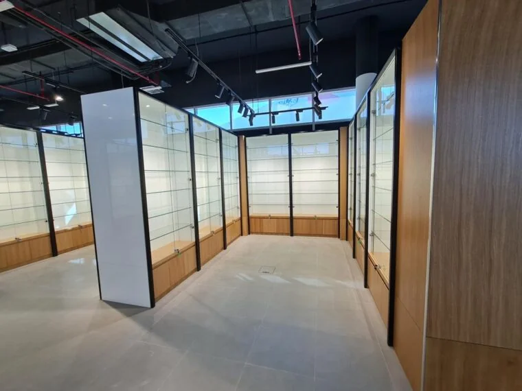 Interior with glass partitions, timber finishes and exposed ceiling